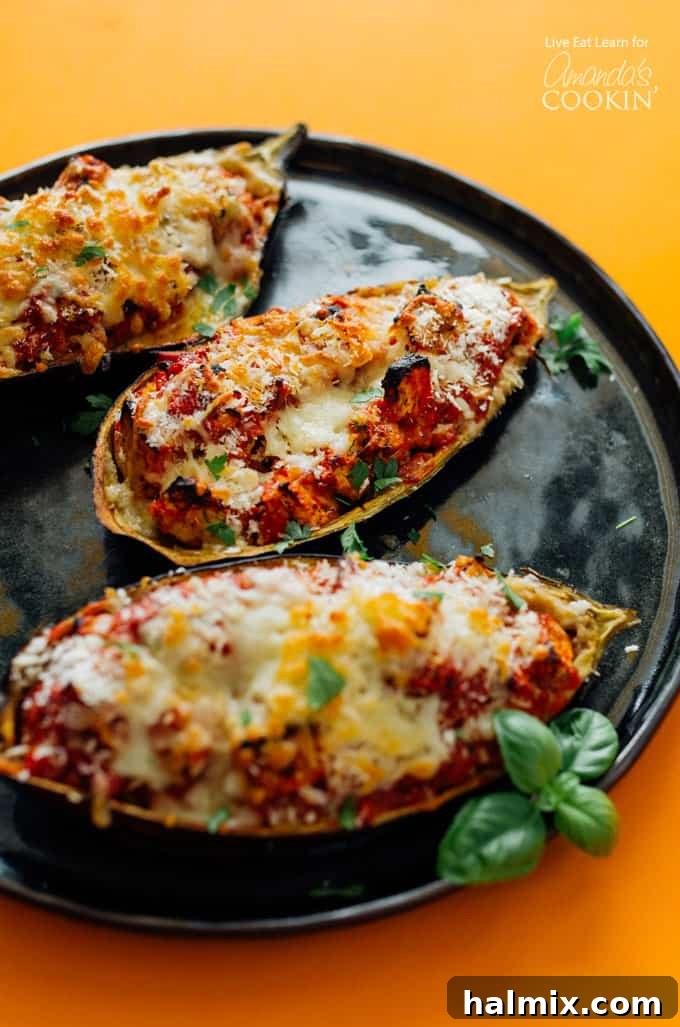 cooked eggplant on a black plate, perfectly golden and bubbly with cheese