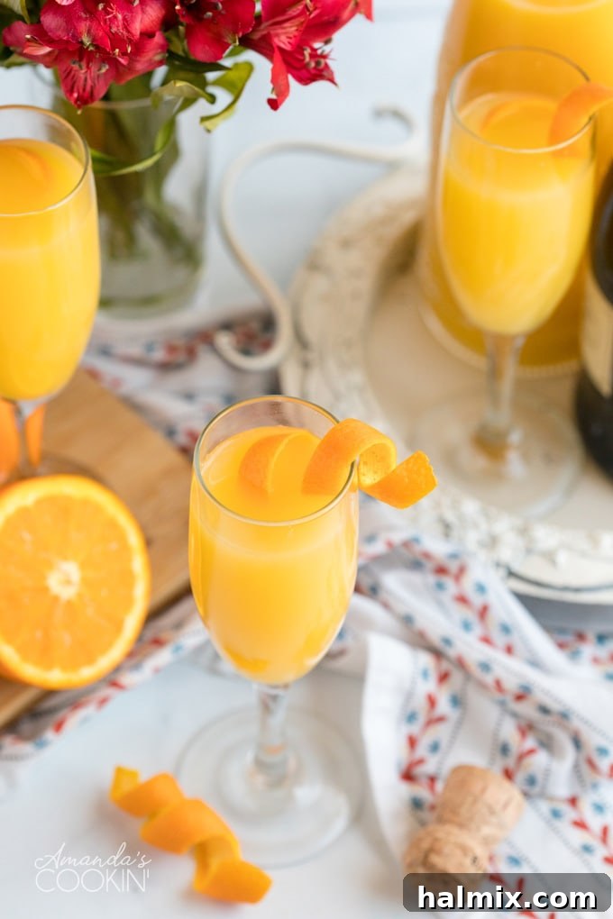A glass of Mimosa garnished with an orange twist