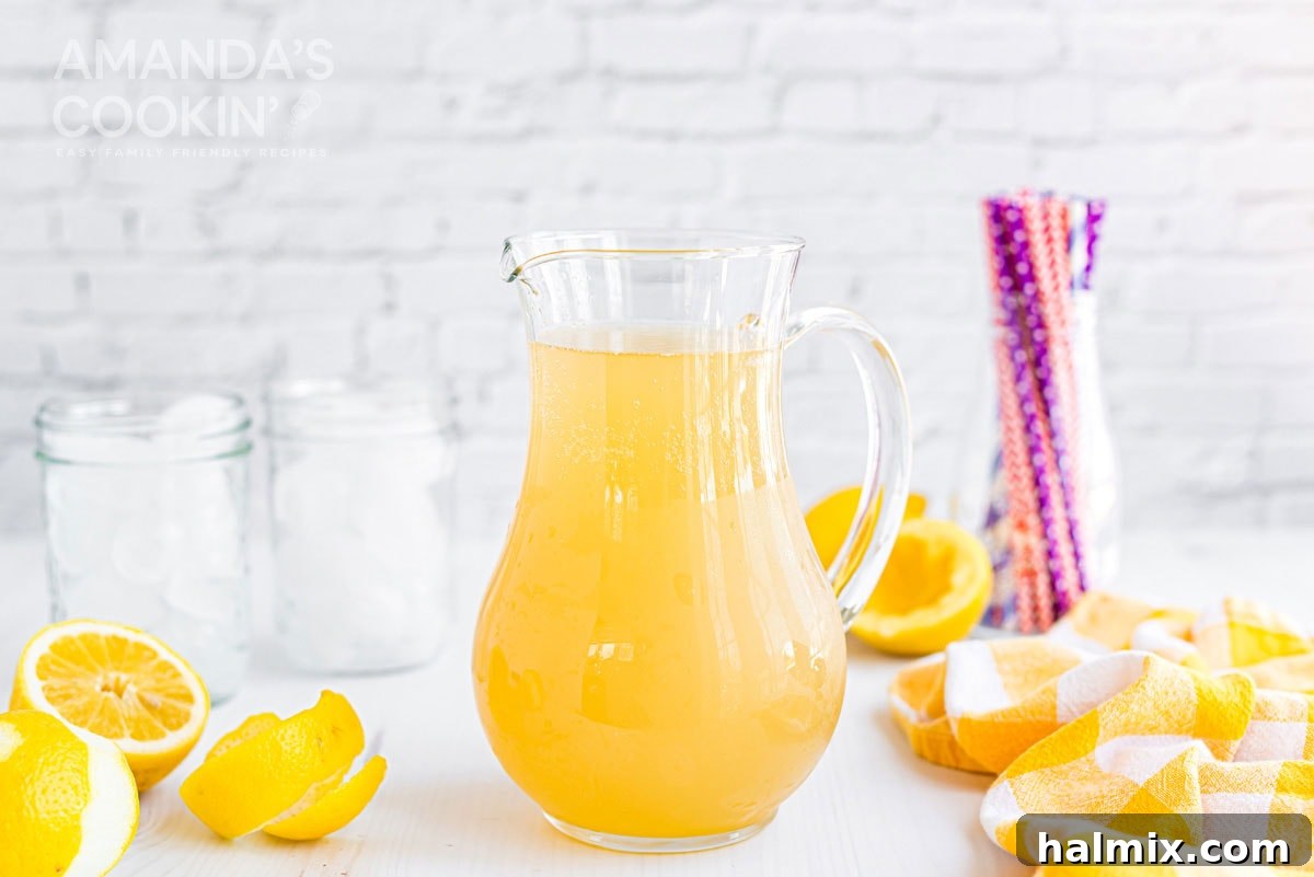 Lynchburg's Golden Refreshment 11 A full pitcher of Lynchburg lemonade, garnished with lemon slices, ready to be poured and enjoyed.