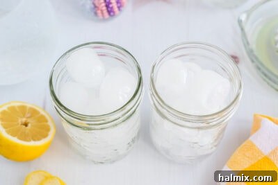Lynchburg's Golden Refreshment 15 Mason jar glasses filled with ice, ready for the Lynchburg Lemonade.
