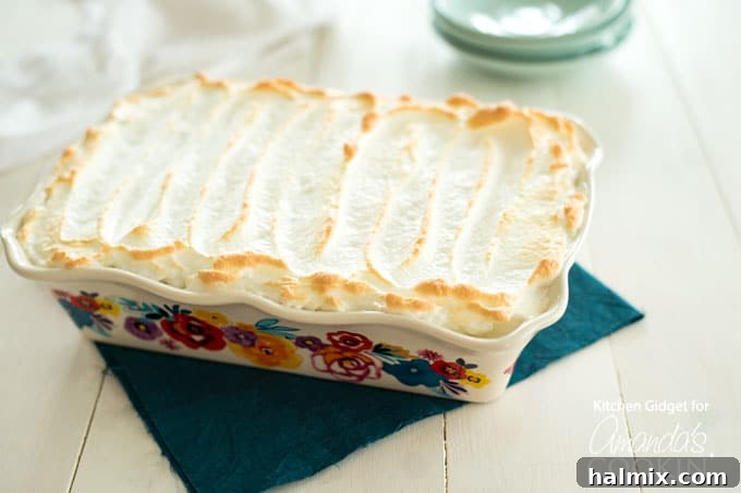 Homemade Banana Pudding with golden meringue topping and vanilla wafers peeking through!
