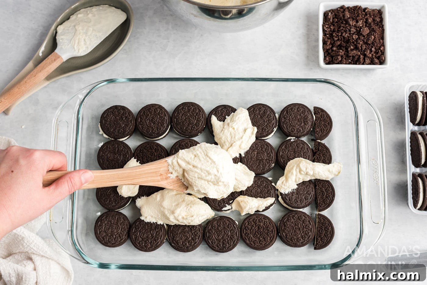 layer of oreos on bottom of a baking dish with scooped whipped topping