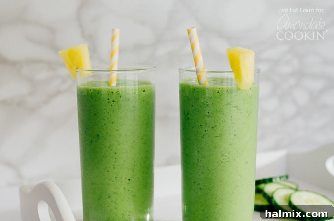Sip on pure tropical bliss with these refreshing Cucumber Tropical Smoothies, perfectly garnished and ready to enjoy. #tropicaldrinks #smoothielove #healthyrefreshment #cucumbergoodness Close-up of two cucumber tropical smoothies in glasses, garnished with fresh pineapple wedges, ready to serve.