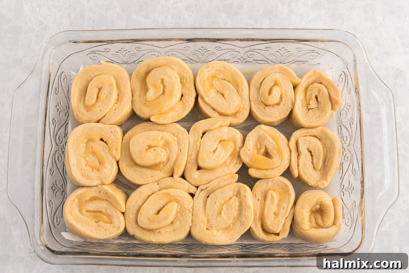 Lemon sweet rolls placed in a baking pan before their second rise.