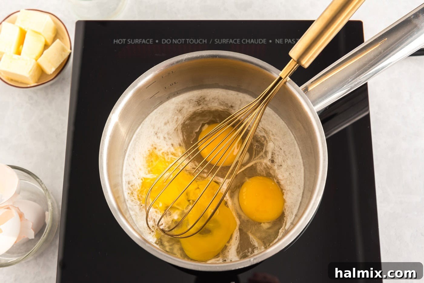 Whisking eggs with lemon juice and sugar in a saucepan for lemon curd.