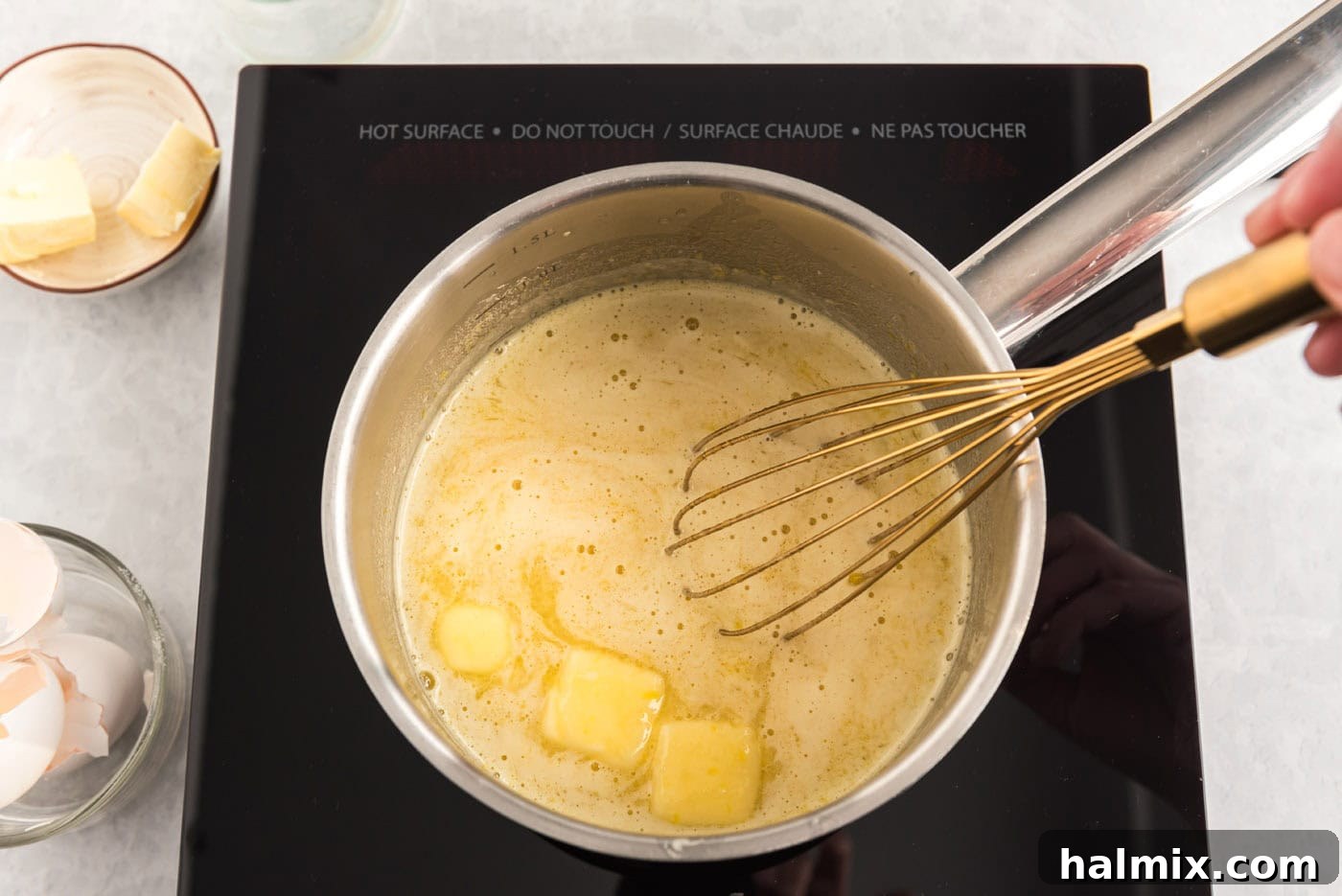 Whisking butter into the egg and lemon juice mixture for the curd.