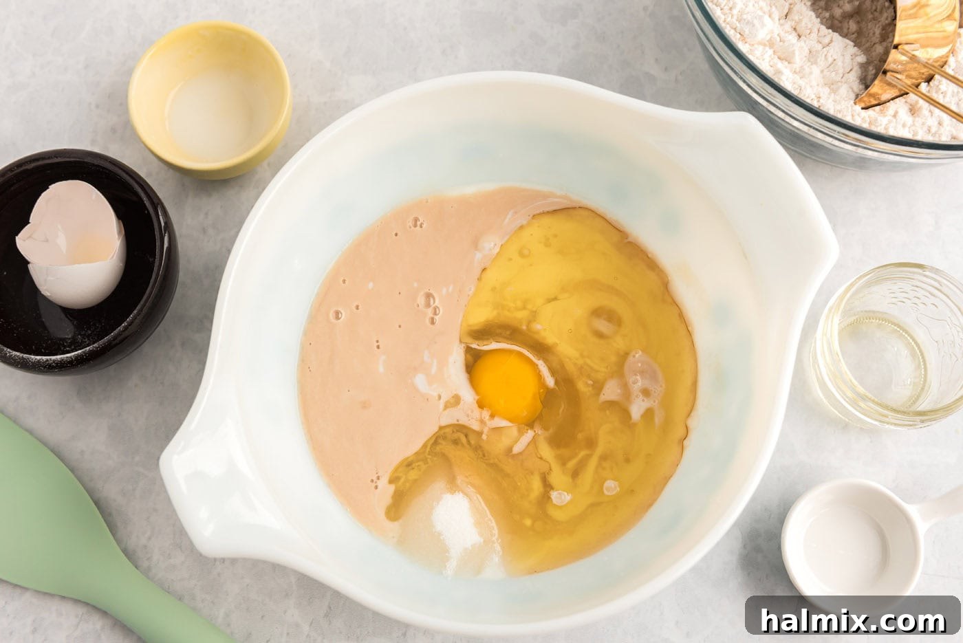 Sugar, buttermilk, egg, and oil added to the yeast mixture in a bowl for lemon sweet roll dough.