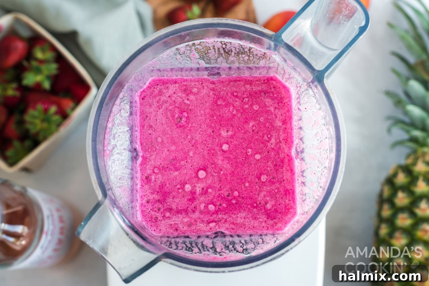 The blender shows pureed frozen fruit and wine, transformed into a smooth, thick slushy consistency.