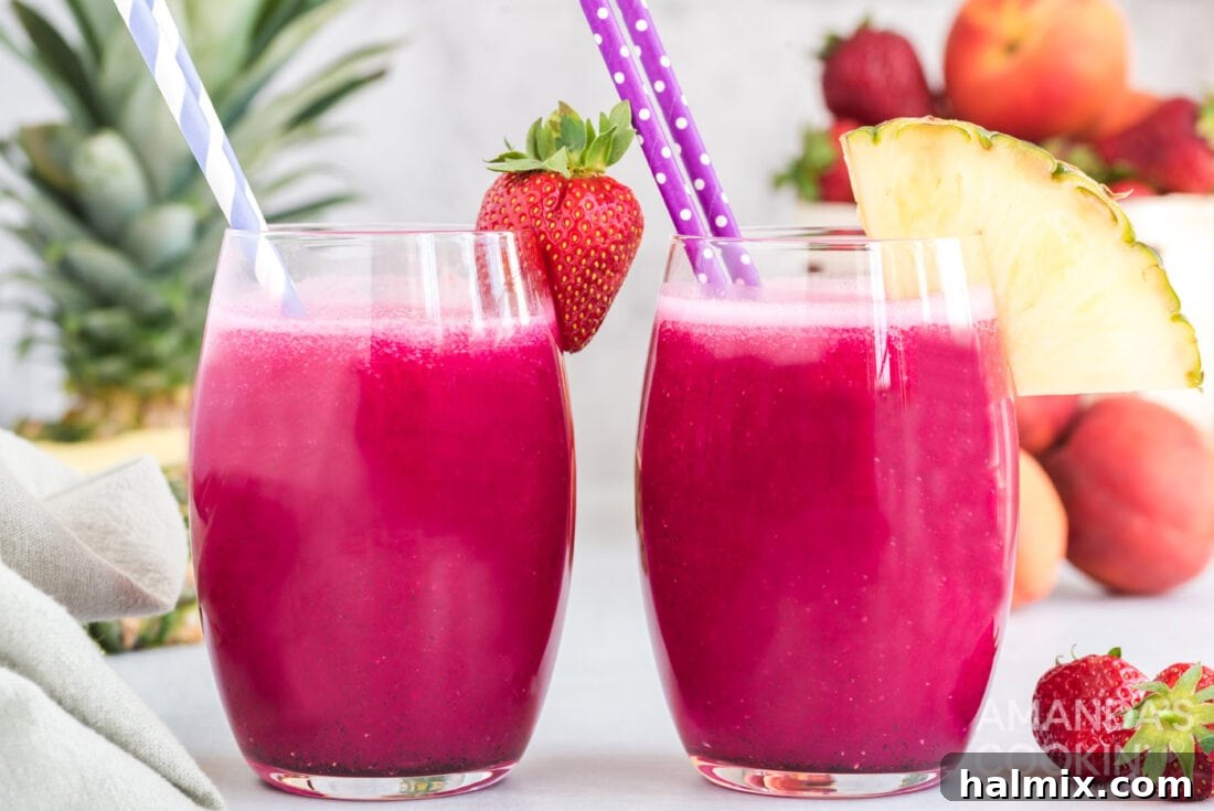 Two glasses of vibrant wine slushies, garnished with fresh fruit, on a table, perfect for a summer gathering.