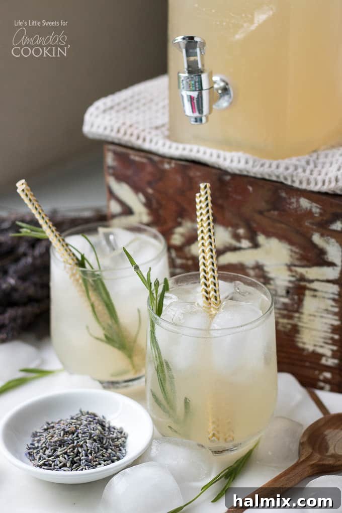 Lavender Lemonade in a wine glass with fresh lavender flowers