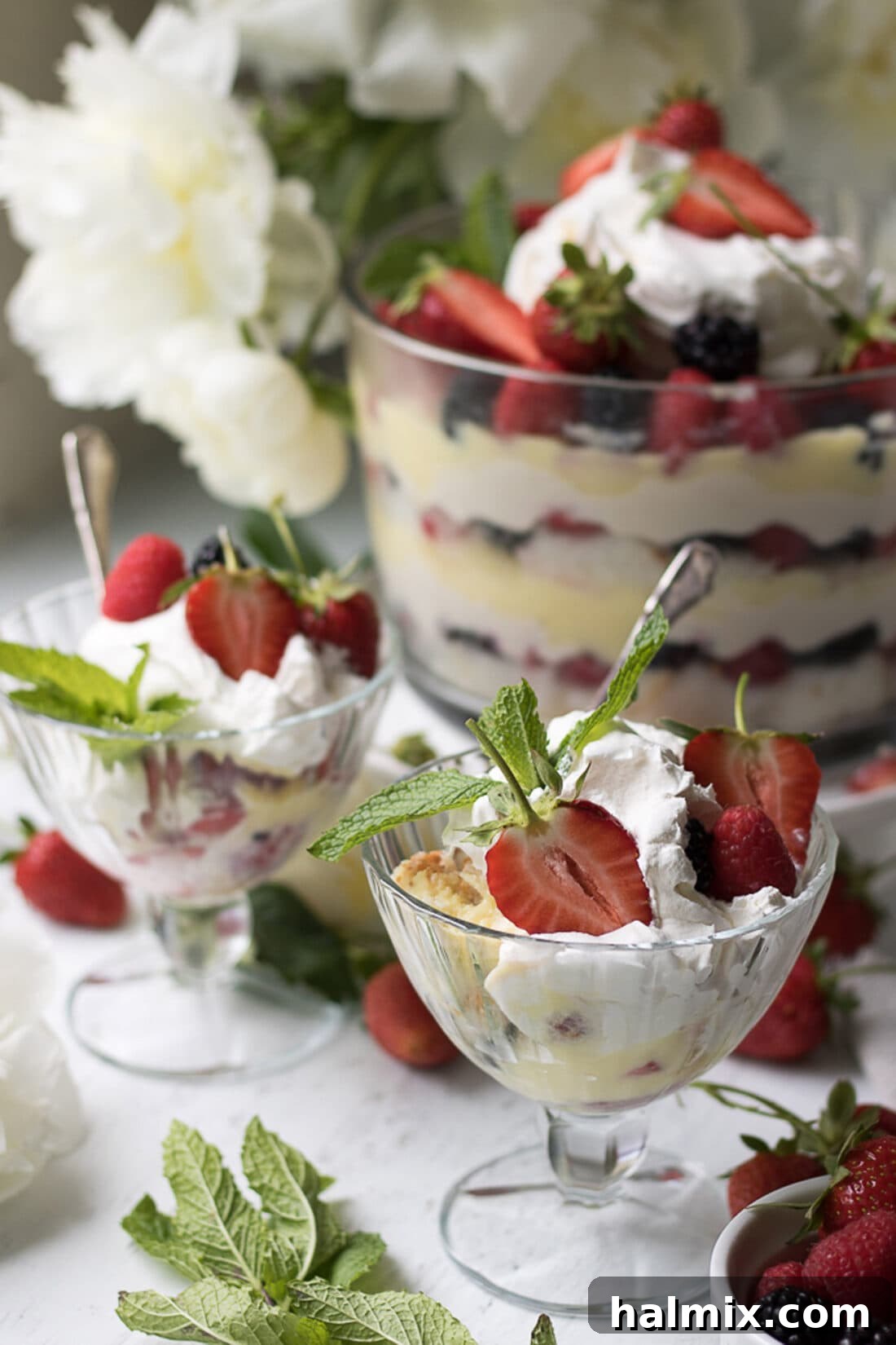 Individual servings of Mixed Berry Trifle in sundae cups, perfect for parties.