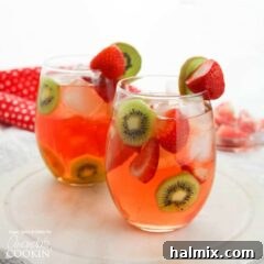 Two glasses of Strawberry Kiwi Sangria with fruit garnishes.
