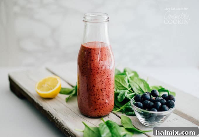 Enjoy this creamy, velvety blueberry vinaigrette salad dressing – easy to make, healthy, and perfect for storage. Blueberry vinaigrette dressing in a decorative glass bottle