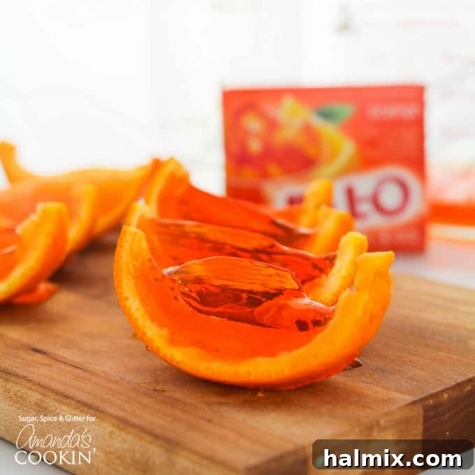 Close-up of several orange jello shot wedges arranged attractively, showcasing their vibrant color.