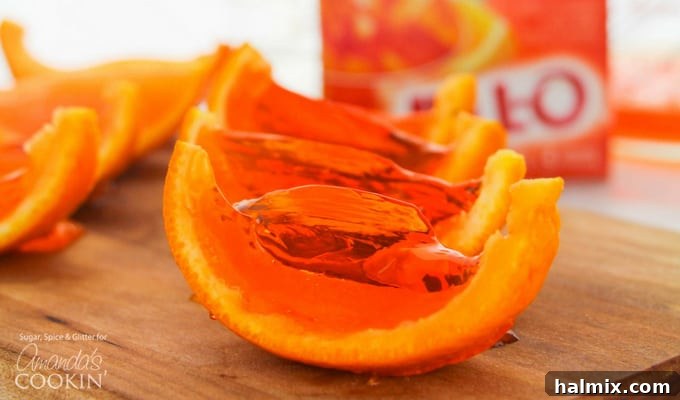 Various orange Jell-O shot wedges beautifully arranged, highlighting their vibrant color and unique presentation.