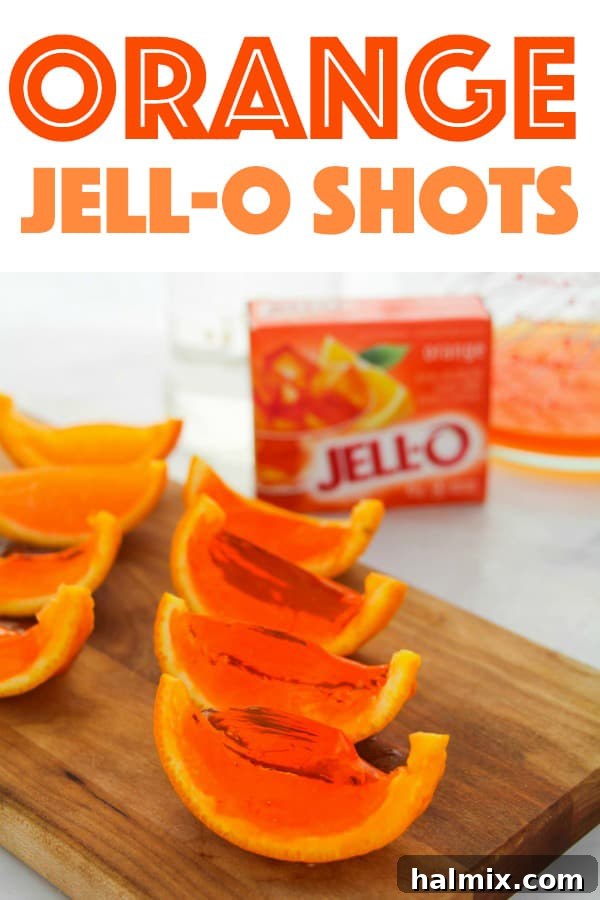Beautifully arranged orange jello shots in rinds on a serving tray, perfect for any social event.
