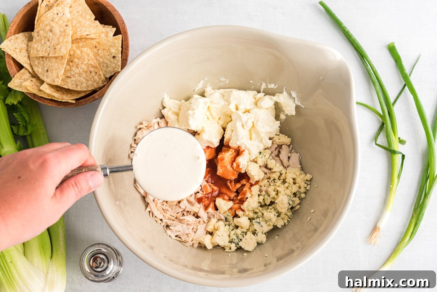 Ultimate Buffalo Chicken Dip 5 Blue cheese, ranch dressing, buffalo sauce, shredded chicken, and cream cheese combined in a mixing bowl