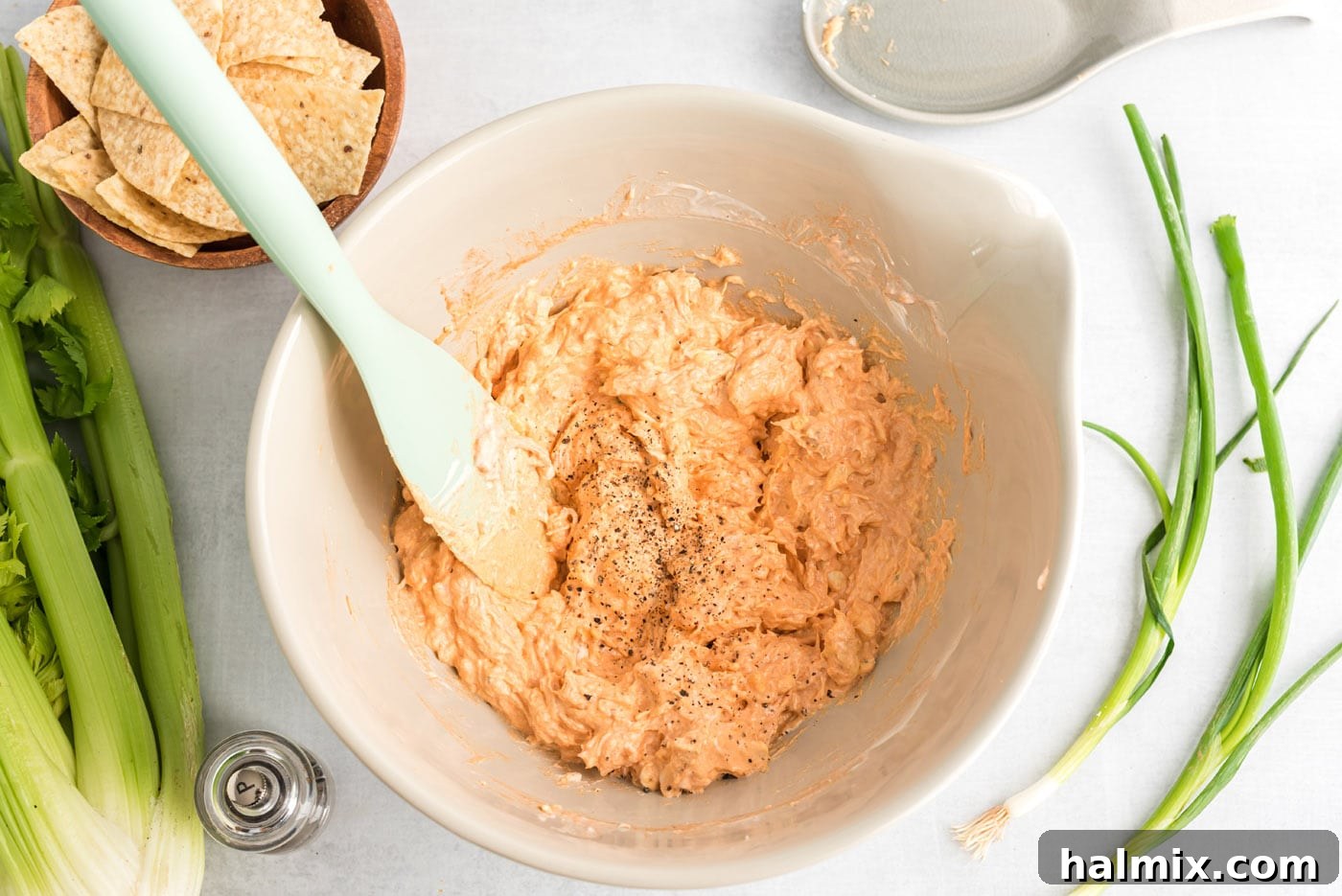 Ultimate Buffalo Chicken Dip 6 Rubber spatula mixing the buffalo chicken dip ingredients until smooth