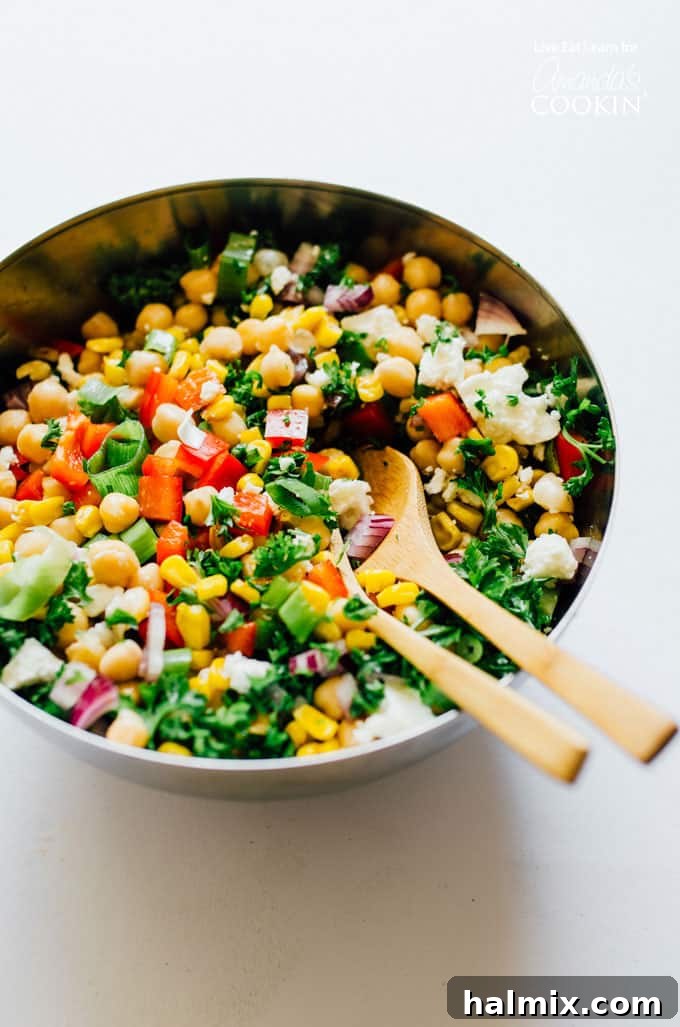 This Sweetcorn and Chickpea Salad recipe is quick to whip up and so tasty. It's filled with healthy proteins and packed with flavor! Assortment of fresh sweet corn and chickpea salad ingredients in a mixing bowl