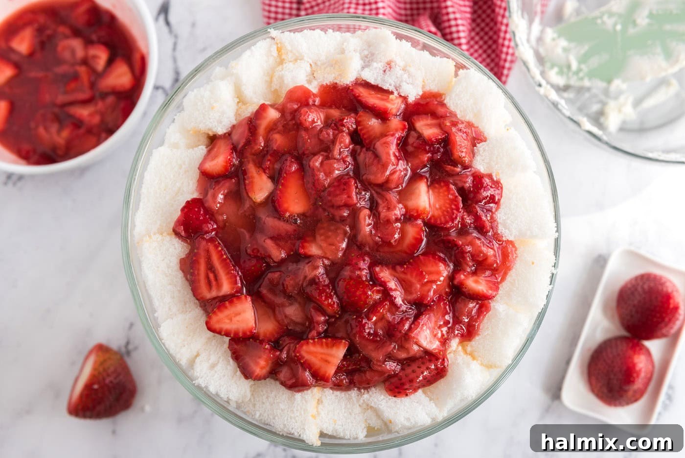 layer of macerated strawberries on top of strawberry shortcake trifle