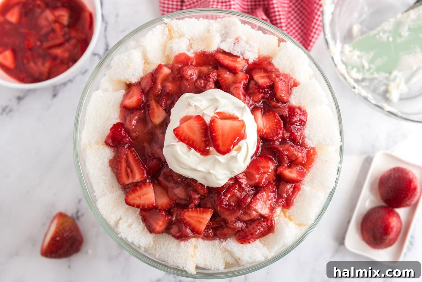 strawberry shortcake trifle garnished with whipped cream and strawberries