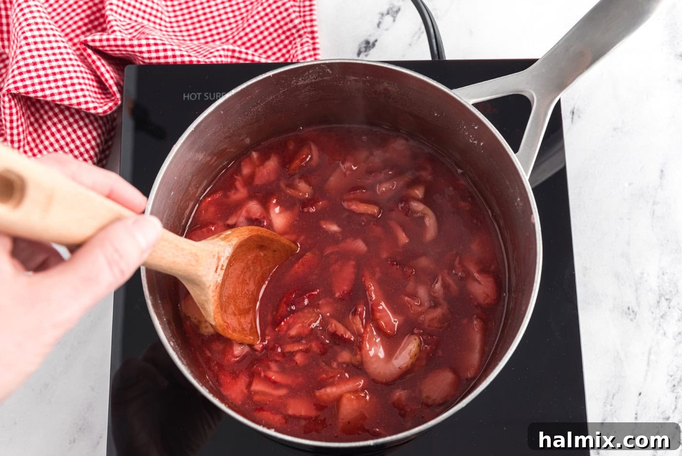 thickened homemade strawberry sauce in a saucepan