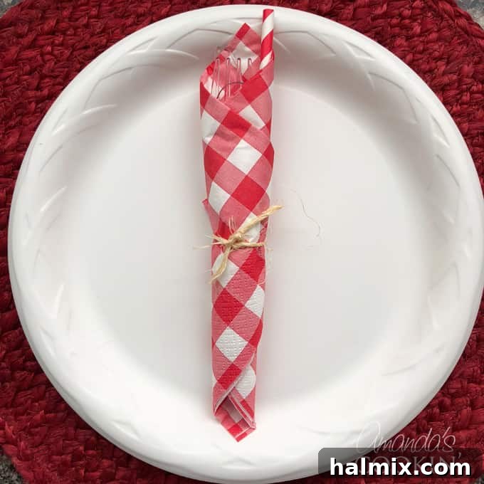 cute napkin wrapped utensils for backyard barbecue