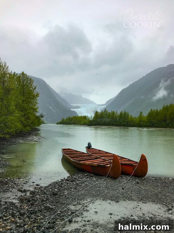 Discover the majestic Davidson Glacier on a canoe tour from Skagway, Alaska. An essential Alaska cruise excursion for nature lovers! #alaskancruise #alaskaexcursion #canoetour #glaciertour #skagwayalaska #visitalaska #travelalaska #sponsored #princesscruises @princesscruises #comebacknew canoes on shore with Davidson Glacier in the background
