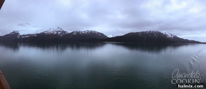 A serene twilight view of the Alaskan landscape, with dark silhouettes against a glowing sky, evoking the peaceful beauty of the region.