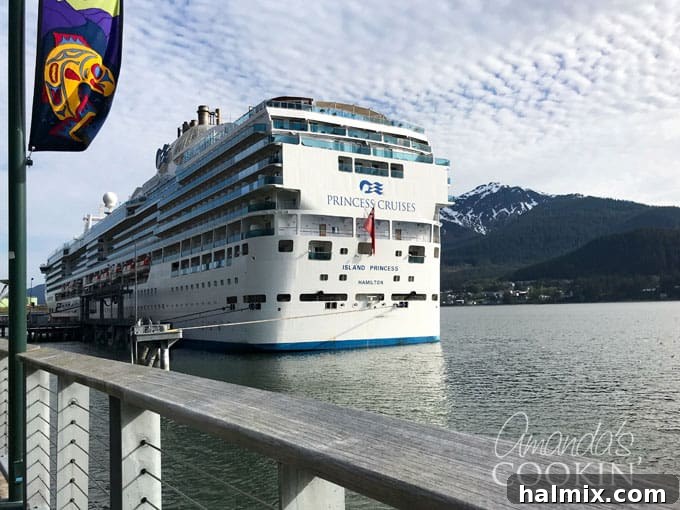 The majestic Island Princess cruise ship gracefully sailing on calm, blue waters, framed by a clear sky, highlighting its grandeur.