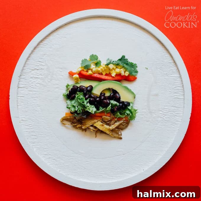 The making of Mexican style summer rolls with clear assembly steps. Detailed step-by-step process of assembling Mexican style summer rolls, showcasing fresh vegetables and seasoned oyster mushrooms being placed onto a softened rice paper wrapper.