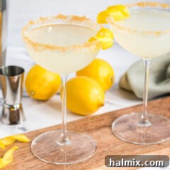 A vibrant Lemon Drop cocktail in a martini glass with a lemon slice garnish.