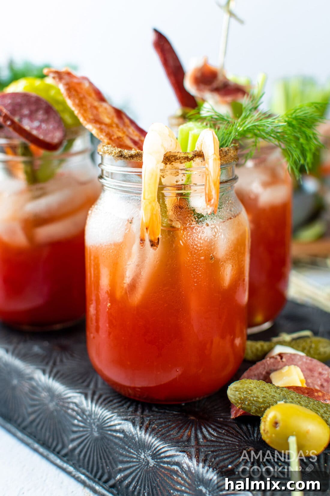 Say Her Name 2 bloody mary drink with bacon and shrimp, garnished elaborately