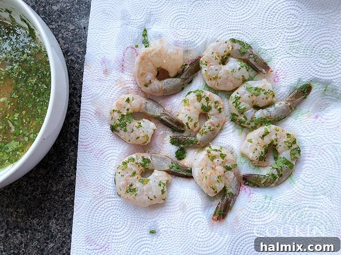 Zesty Prawn Sizzle 5 drain marinated shrimp on paper towels