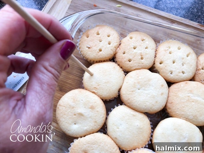 Watermelon Burst Cupcakes 3 Poking holes in baked cupcakes with a wooden skewer