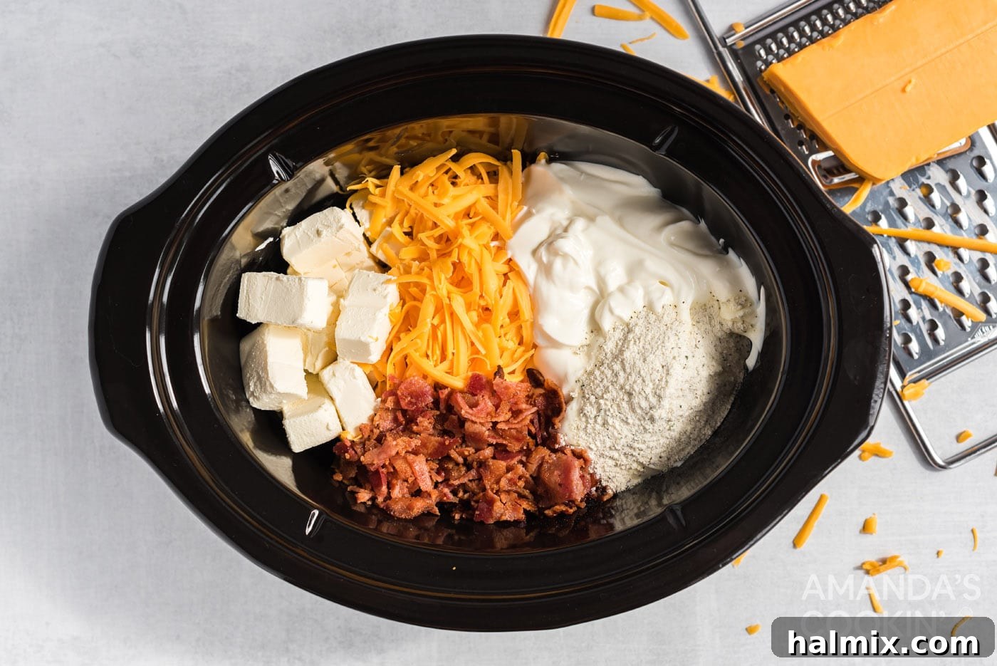 All ingredients for the cheese dip are placed into the crockpot, ready for cooking.
