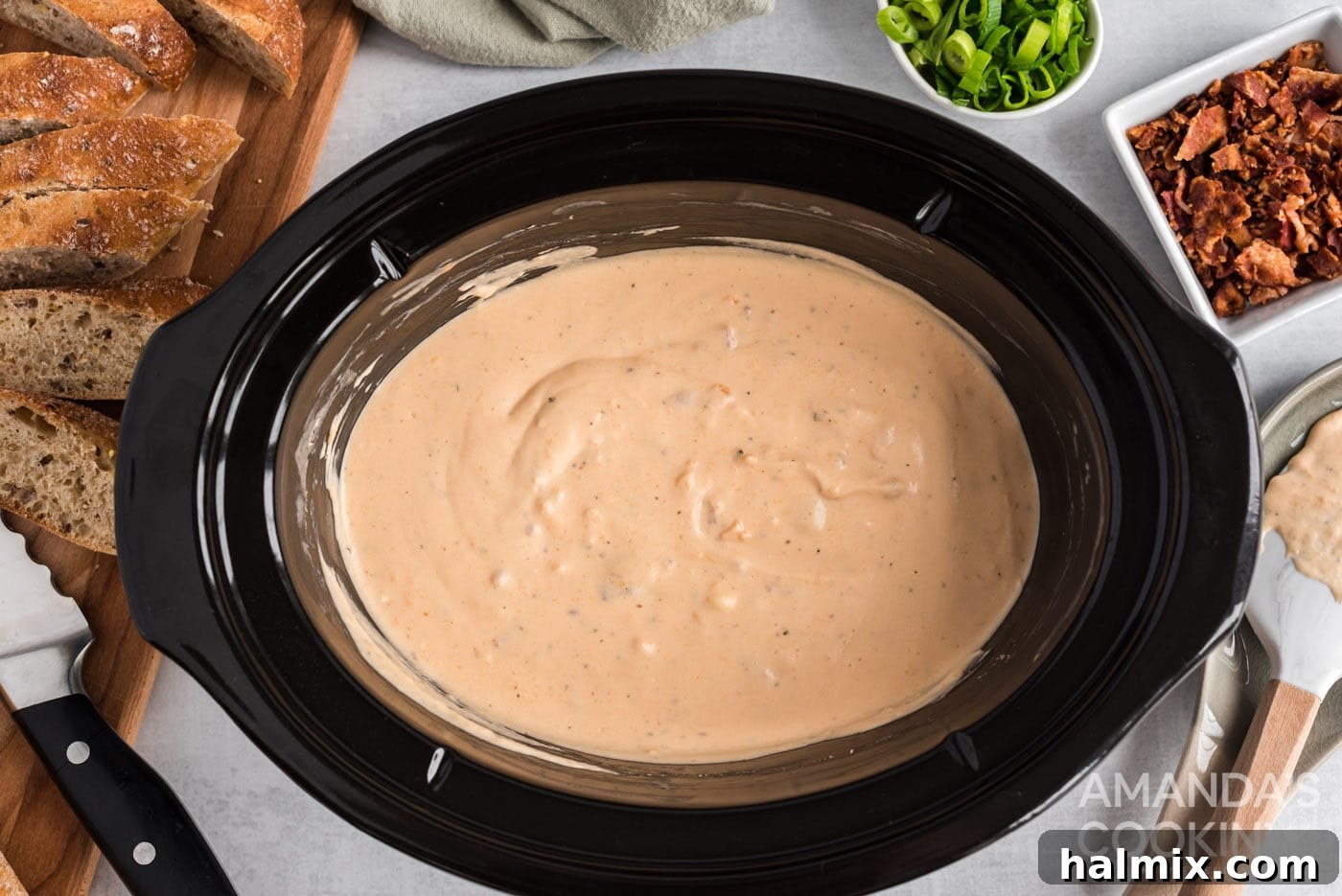 The finished crockpot cheese dip served in a rustic ceramic bowl, ready to be enjoyed.