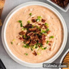A top-down view of a bowl of Crockpot Cheese Dip, golden and creamy, ready for serving.
