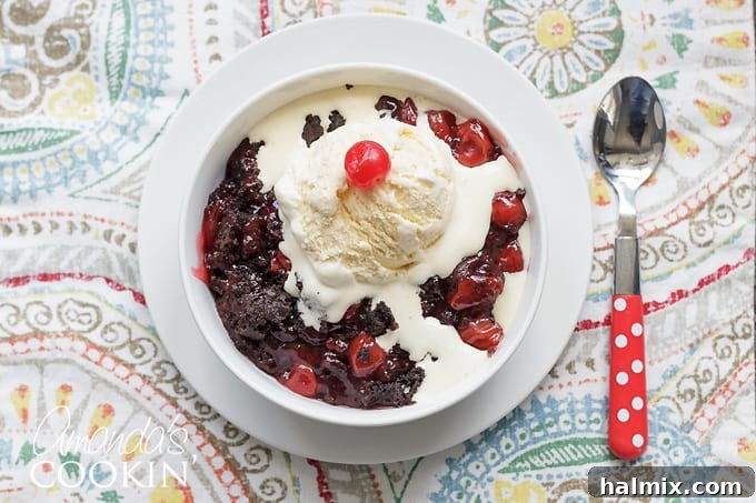 Full crockpot filled with cooked chocolate cherry cobbler, a perfect warm dessert.