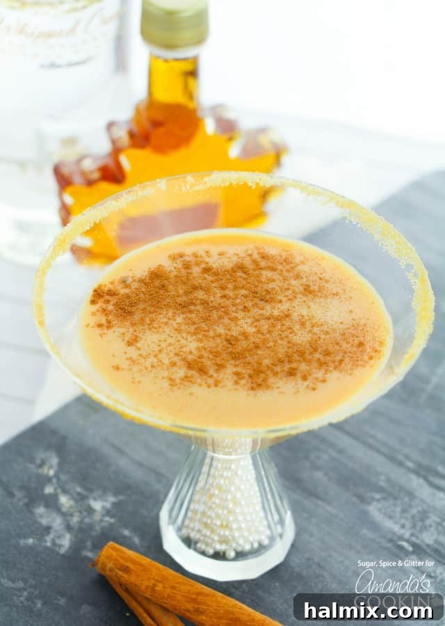 Pumpkin Pie martini with pumpkin spice and maple syrup garnish.