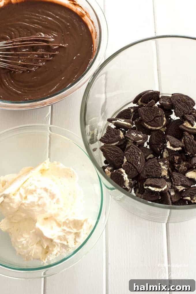 Oreos, chocolate pudding, and whipped topping in bowls