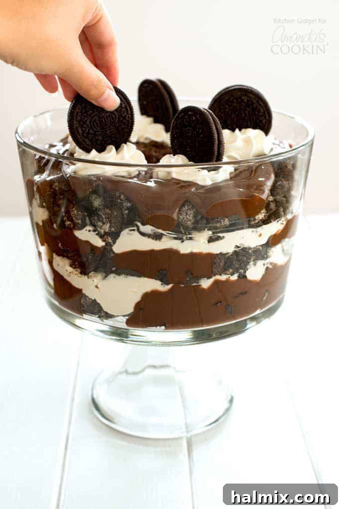 Placing an oreo on top of Chocolate Lasagna Trifle