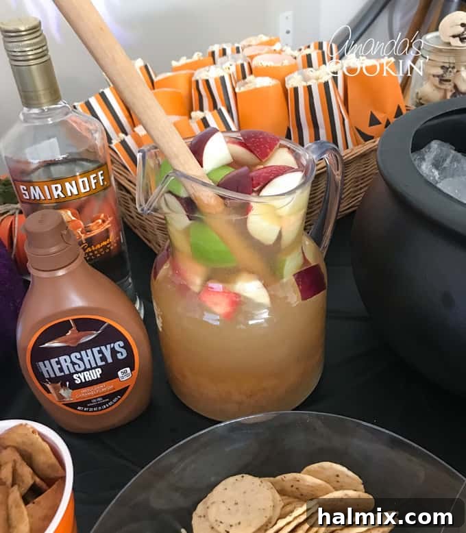Wicked Halloween Bites 5 Caramel Apple Sangria in a pitcher with sliced apples