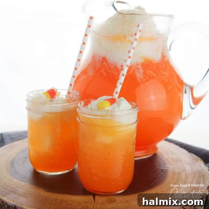 If you need Halloween food ideas for your Halloween party, be sure to check out all these sweet, savory and beverage ideas! Something for everyone. Two glasses of layered Candy Corn Punch with a pitcher in the background