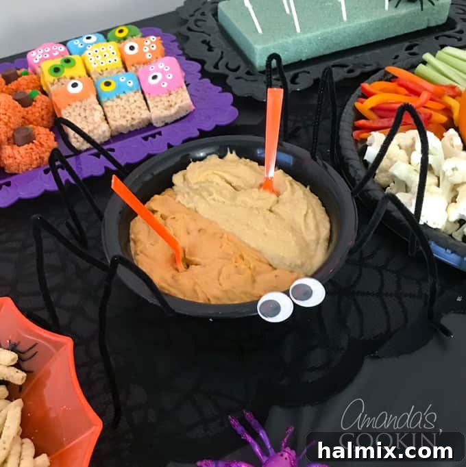 Wicked Halloween Bites 2 Hummus served in a spider-themed bowl with pipe cleaner legs