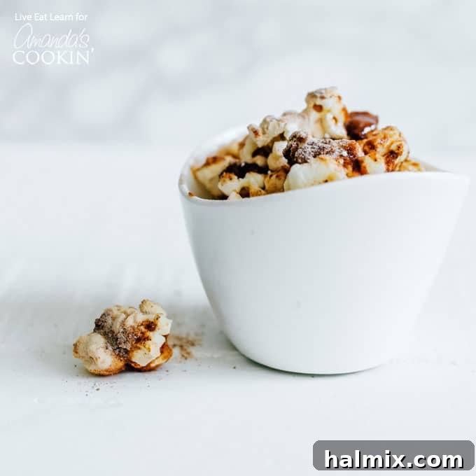 A close-up shot of a bowl brimming with perfectly seasoned popcorn, showcasing the even distribution of flavorful spices on each fluffy kernel.