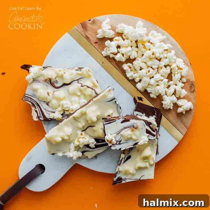 A delicious homemade treat featuring crunchy popcorn chocolate bark, artfully decorated and perfect for holiday gifting or any special gathering, showcasing a delightful salty-sweet balance.