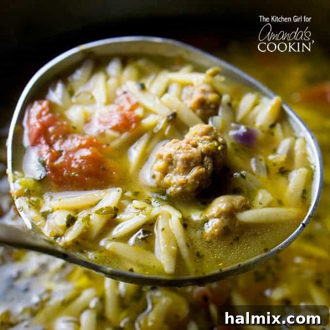 Comforting Slow Cooker Butternut Squash Soup 2 A ladle full of hearty Orzo and Sausage soup, showing rich broth and ingredients.