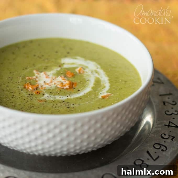 Comforting Slow Cooker Butternut Squash Soup 4 A bowl of creamy asparagus soup garnished with fresh herbs.