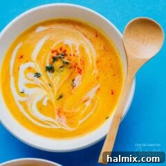 Comforting Slow Cooker Butternut Squash Soup 5 creamy cauliflower soup in a bowl with wooden spoon